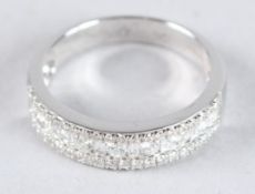 AN 18CT WHITE GOLD AND DIAMOND HALF HOOP RING.