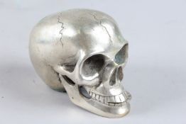 A SILVER PLATED SKULL. 4ins high.