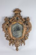 AN EARLY 18TH CENTURY ITALIAN CARVED AND GILDED MIRROR carved with scrolls, masks and flowers. 28ins