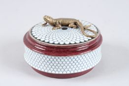 A PORCELAIN CIRCULAR BOX AND COVER with lizard handle. 5.5ins diameter.