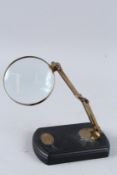 A MAGNIFYING GLASS ON A STAND.