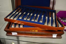 A CASED SET OF EIGHTEEN SILVER HANDLED DESSERT KNIVES AND FORKS.