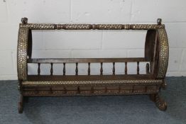 A RARE 19TH CENTURY ISLAMIC CIRCULAR ROCKING CRADLE inlaid with mother-of-pearl. 3ft 3ins long x 1ft