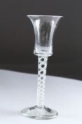 A GEORGIAN WINE GLASS with inverted bell bowl and white air twist stem. 6ins high.