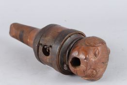 A RARE 19TH CENTURY CARVED WOOD WINE KEG PLUG, carved as a bear's head. 10ins long.
