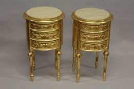 A PAIR OF LOUIS XVITH DESIGN GILTWOOD ROUND THREE DRAWER CHESTS on tapering legs. 2ft 2ins high x