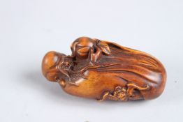 A CARVED WOOD GOD AND PEACH FIGURE. 3ins high.