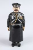 A RUSSIAN BRONZE STANDING POLICEMAN with sword and medals. 7.5ins high. Mark on the feet.