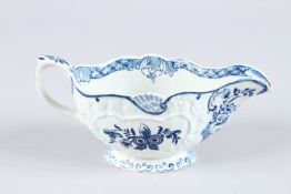 A BOW BLUE AND WHITE MOULDED FLORAL PATTERN SAUCEBOAT with shell motifs. Circa 1758 - 1762. 7.