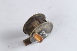 A SMALL BRASS FISHING REEL BY BOWNESS, 230 THE STRAND, LONDON. 2.25ins diameter.