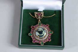 A SILVER GILT, RUBY AND ENAMEL PUG DOG PENDANT.