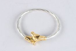 A STERLING SILVER AND GILDED HORSE HEAD BANGLE.
