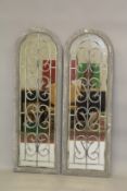 A PAIR OF GREY ARCHED GARDEN MIRRORS. 4ft high x 1ft 4ins wide.