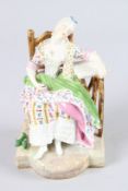 A 19TH CENTURY MEISSEN FIGURE, a woman asleep in a chair, 6.5ins high. Crossed sword marks in