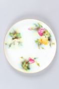 A ROYAL WORCESTER PLATE painted with roses. 9ins diameter.