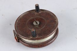 A SMALL METAL REEL. 1.75ins, together with a Bakelite reel.