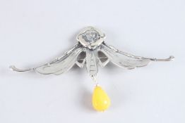 A SILVER AND AMBER BROOCH.