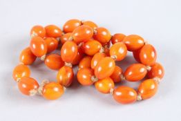 A STRING OF BUTTERSCOTCH AMBER BEADS. 26ins long.