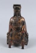 A CHINESE GILDED BRONZE DEITY. 9.5ins high.