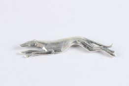 A SILVER GREYHOUND BROOCH.