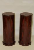 A PAIR OF FIGURED WOOD DECO CIRCULAR STANDS. 2ft 7ins high x 1ft diameter.