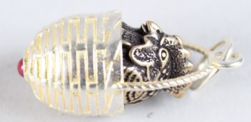 A SILVER CHICK AND BASKET PENDANT.