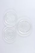 A SET OF THREE LALIQUE TYPE BIRD AND FISH PLATES, 1973, 1974 and 1975. 8ins diameter.