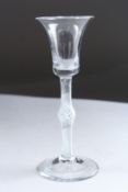A GEORGIAN WINE GLASS with inverted bell bowl on air twist stem with knop. 6ins high.