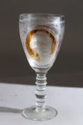 A LARGE CONTINENTAL ALE OR WINE GLASS, part amber tinted, engraved with panels depicting building,