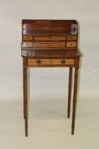 A GOOD LITTLE MAHOGANY WRITING TABLE with six drawers to the top over a long drawer and supported on