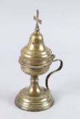 A CONTINENTAL BRASS RELIGIOUS VESSEL with cross finial. 8.5ins high.