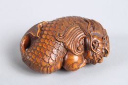 A CARVED WOOD DRAGON FISH. 2.5ins long.