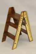 A BOLLINGER WOODEN FOLDING LADDER. 2ft 10ins high.