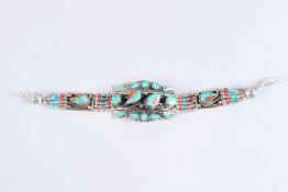 A TIBETAN TURQUOISE, SILVER AND CORAL BRACELET.