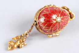 A RUSSIAN RED ENAMEL EGG PENDANT.
