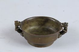 A SMALL CHINESE BRONZE DRAGON BOWL. 3.5ins diameter.
