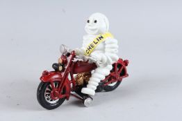 A CAST IRON MICHELIN MAN ON A BIKE. 8ins high.