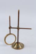 A MAGNIFYING GLASS ON A STAND.