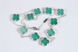 A SILVER CLOVER NECKLACE.
