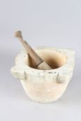 A LARGE MARBLE PESTLE AND MORTAR.