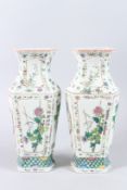 A PAIR OF 19TH CENTURY HEXAGONAL VASES, painted with panels and flowers and birds. 14cms high.