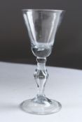 A GEORGIAN WINE GLASS with teardrop and knop stem. 6ins high.