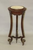 A TALL MARBLE TOP TORCHERE on three curving legs, with under-tier. 3ft 5ins high x 4ft 6ins
