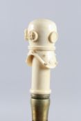 A WALKING STICK WITH A CARVED BONE HANDLE, DIVER'S HELMET.