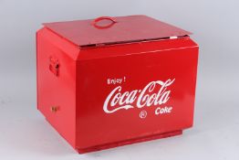 A RED COCA COLA COOL BOX.