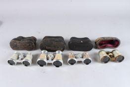FOUR VARIOUS EDWARDIAN OPERA GLASSES in leather cases.