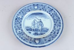 A DUTCH 18TH CENTURY CIRCULAR BLUE AND WHITE PLATE decorated with two figures in a landscape.