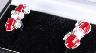 A PAIR OF STERLING SILVER AND RED ENAMEL RACING CAR CUFFLINKS.
