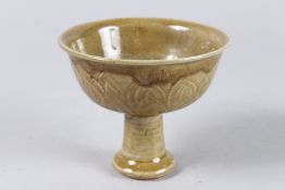 A CHINESE CELADON STEM CUP. 5ins diameter.