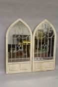 A PAIR OF WHITE ARCHED GARDEN MIRRORS. 4ft 8ins high x 2ft 2ins wide.